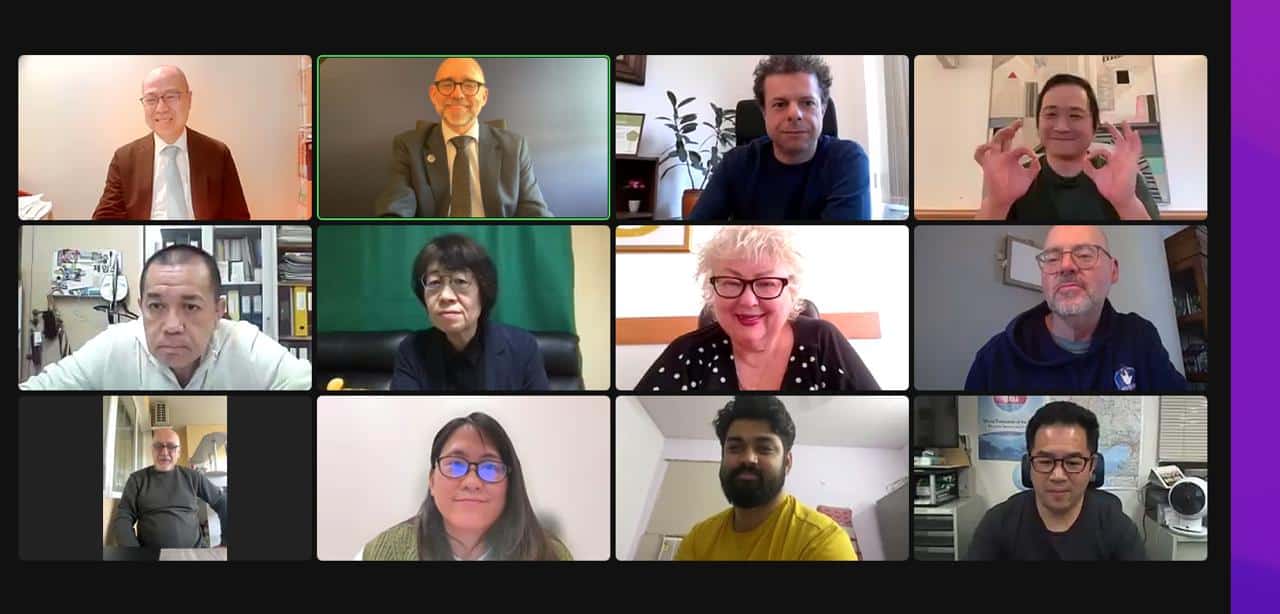 A grid of twelve people in a virtual meeting, each in their own frame, with varied expressions and backgrounds.