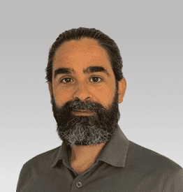 A man with a beard and a grey shirt