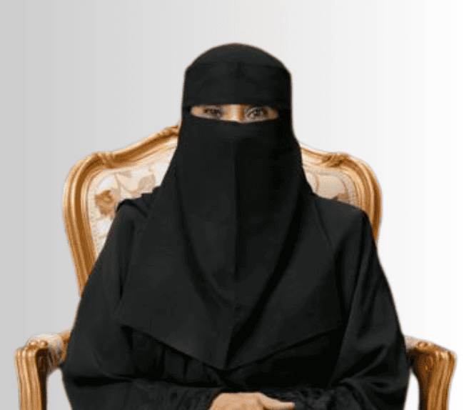 A person wearing a black niqab sits on an ornate chair with a light, patterned backrest against a neutral background.