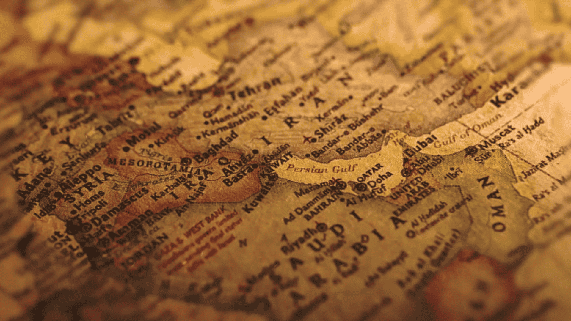 A close-up of a vintage map showing geographic locations in the Middle East, including Iran, Iraq, Saudi Arabia, Oman, the Persian Gulf, and surrounding areas.