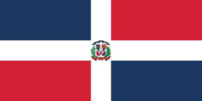 The flag of the Dominican Republic with a centered coat of arms, featuring blue and red quarters divided by a white cross.