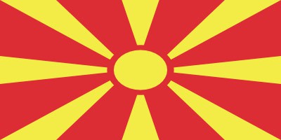 Flag of North Macedonia with a yellow sun and rays on a red background.