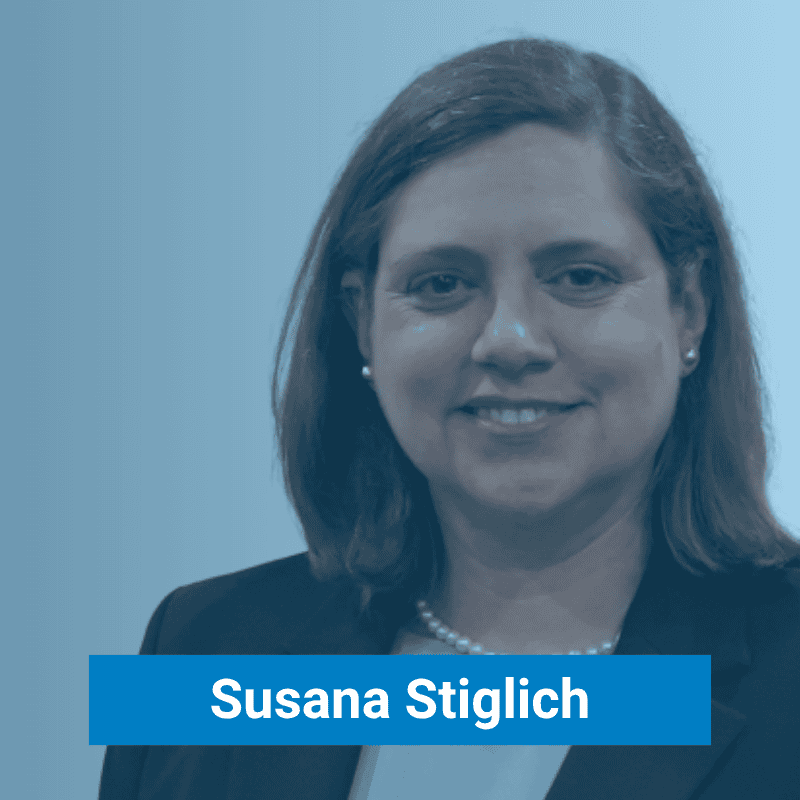 A woman with shoulder-length brown hair, wearing a black blazer, white top, and pearl necklace, stands against a blue gradient background. The name "Susana Stiglich" is displayed in bold text.