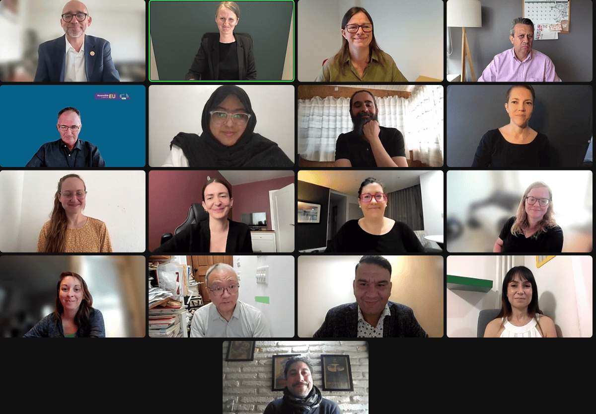 A virtual meeting with fifteen people visible in a grid layout. Each person appears in their own square, sitting indoors, looking at their screens.